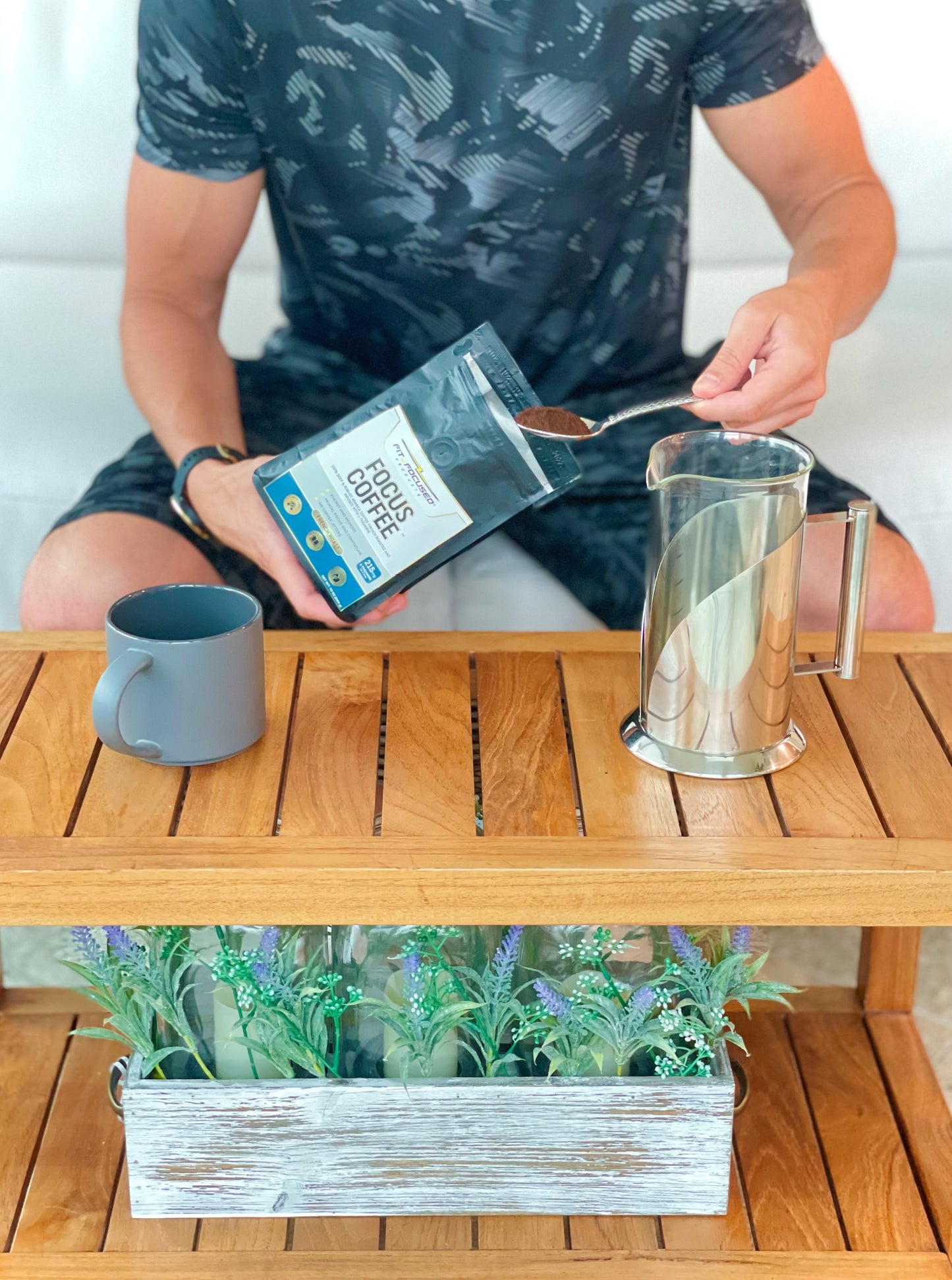 Person In Athleticwear Scooping Fit and Focused L-Theanine Infused Focus Coffee Into French Press